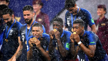 MOSCOW, RUSSIA - JULY 15: Kylian Mbappe, Ousmane Dembele and Presnel Kimpembe of France celebrate victory follwing the 2018 FIFA World Cup Final between France and Croatia at Luzhniki Stadium on July 15, 2018 in Moscow, Russia. (Photo by Laurence Griffiths/Getty Images)