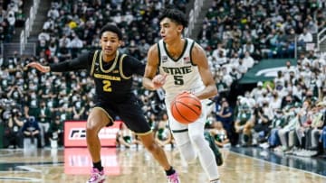 Michigan State's Max Christie, right, moves with the ball as Michigan's Kobe Bufkin defends during the second half on Saturday, Jan. 29, 2022, at the Breslin Center in East Lansing.220129 Msu Mich 224a