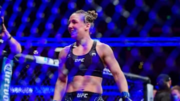 Jan 22, 2022; Anaheim, California, USA; Vanessa Demopoulos (blue gloves) reacts to her win by submission over Silvana Gomez Juarez (red gloves) during UFC 270 at Honda Center. Mandatory Credit: Gary A. Vasquez-USA TODAY Sports