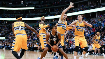 Apr 10, 2016; Denver, CO, USA; Utah Jazz guard Rodney Hood (5) controls the ball against Denver Nuggets center Jusuf Nurkic (23) and center Nikola Jokic (15) and forward Will Barton (5) and guard Emmanuel Mudiay (0) in the second quarter at the Pepsi Center. Mandatory Credit: Isaiah J. Downing-USA TODAY Sports