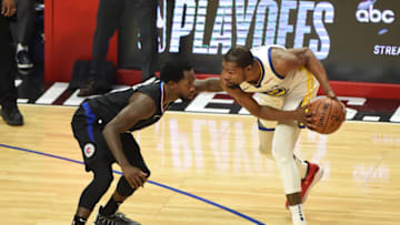 LOS ANGELES, CA - APRIL 21: Kevin Durant #35 of the Golden State Warriors guards the ball during the game against Patrick Beverley #21 of the LA Clippers during Game Four of Round One of the 2019 NBA Playoffs on April 21, 2019 at STAPLES Center in Los Angeles, California. NOTE TO USER: User expressly acknowledges and agrees that, by downloading and/or using this Photograph, user is consenting to the terms and conditions of the Getty Images License Agreement. Mandatory Copyright Notice: Copyright 2019 NBAE (Photo by Adam Pantozzi/NBAE via Getty Images)