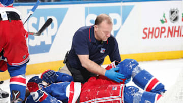 NEW YORK, NY - NOVEMBER 20: The New York Rangers Head Athletic Trainer Jim Ramsay tends to Mika Zibanejad #93 after he injures his leg during the game against the Florida Panthers at Madison Square Garden on November 20, 2016 in New York City. The Florida Panthers won 3-2 in a shootout. (Photo by Jared Silber/NHLI via Getty Images)