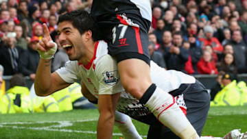 MANCHESTER, ENGLAND - MARCH 16: Luis Suarez of Liverpool celebrates scoring his team's third goal with Martin Skrtel (R) during the Barclays Premier League match between Manchester United and Liverpool at Old Trafford on March 16, 2014 in Manchester, England. (Photo by Alex Livesey/Getty Images)
