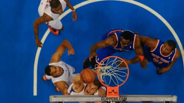 Nov 27, 2013; Los Angeles, CA, USA; Los Angeles Clippers power forward Blake Griffin (bottom) shoots as teammates center Ryan Hollins (bottom left) and shooting guard Reggie Bullock (top left) and New York Knicks power forward Amar