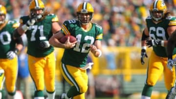 Sep 14, 2014; Green Bay, WI, USA; Green Bay Packers quarterback Aaron Rodgers (12) runs with the ball during the first quarter of a game against the New York Jets at Lambeau Field. Mandatory Credit: Dennis Wierzbicki-USA TODAY Sports