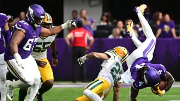 MINNEAPOLIS, MINNESOTA - SEPTEMBER 11: Dalvin Cook #4 of the Minnesota Vikings is tackled by Jaire Alexander #23 of the Green Bay Packers during the second quarter at U.S. Bank Stadium on September 11, 2022 in Minneapolis, Minnesota. (Photo by Stephen Maturen/Getty Images)