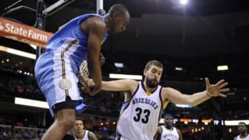 Jan 8, 2016; Memphis, TN, USA; Denver Nuggets guard Emmanuel Mudiay (0) and Memphis Grizzlies center Marc Gasol (33) fight for the ball during the second half at FedExForum. Memphis Grizzlies defeated Denver Nuggets 91 - 84. Mandatory Credit: Justin Ford-USA TODAY Sports