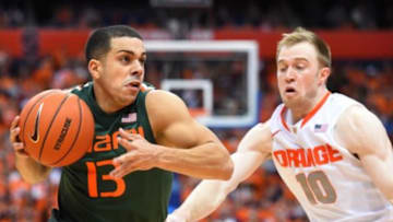 Jan 24, 2015; Syracuse, NY, USA; Miami Hurricanes guard Angel Rodriguez (13) drives to the basket against the defense of Syracuse Orange guard Trevor Cooney (10) during the second half at the Carrier Dome. Miami defeated Syracuse 66-62. Photo Credit: Rich Barnes-USA TODAY Sports