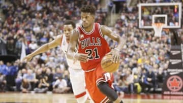 Jan 3, 2016; Toronto, Ontario, CAN; Chicago Bulls guard Jimmy Butler (21) moves around Toronto Raptors guard Kyle Lowry (7) at the Air Canada Centre. Chicago defeated Toronto 115-113. Mandatory Credit: John E. Sokolowski-USA TODAY Sports