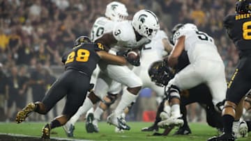 TEMPE, AZ - SEPTEMBER 08: Running back LJ Scott #3 of the Michigan State Spartans rushes the football past defensive back Demonte King #28 of the Arizona State Sun Devils during the college football game at Sun Devil Stadium on September 8, 2018 in Tempe, Arizona. The Sun Devils defeated the Spartans 16-13. (Photo by Christian Petersen/Getty Images)