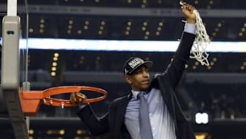 Apr 7, 2014; Arlington, TX, USA; Connecticut Huskies head coach Kevin Ollie waves to fans after cutting down the net following the championship game of the Final Four in the 2014 NCAA Mens Division I Championship tournament against the Kentucky Wildcats at AT&T Stadium. Mandatory Credit: Robert Deutsch-USA TODAY Sports