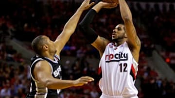 May 12, 2014; Portland, OR, USA; Portland Trail Blazers forward LaMarcus Aldridge (12) shoots over San Antonio Spurs forward Boris Diaw (33) during the fourth quarter in game four of the second round of the 2014 NBA Playoffs at the Moda Center. Mandatory Credit: Craig Mitchelldyer-USA TODAY Sports