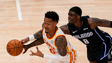 Dec 11, 2020; Atlanta, Georgia, USA; Atlanta Hawks forward John Collins (20) has the ball knocked away from him by Orlando Magic guard Dwayne Bacon (8) during the first half at State Farm Arena. Mandatory Credit: Dale Zanine-USA TODAY Sports
