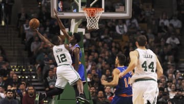 Nov 11, 2016; Boston, MA, USA; Boston Celtics guard Terry Rozier (12) shoots the ball over New York Knicks guard Justin Holiday (8) during the first half at TD Garden. Mandatory Credit: Bob DeChiara-USA TODAY Sports
