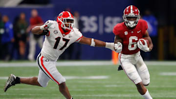 ATLANTA, GEORGIA - DECEMBER 04: Trey Sanders #6 of the Alabama Crimson Tide carries the ball as Nakobe Dean #17 of the Georgia Bulldogs defends during the second half of the SEC Championship game at Mercedes-Benz Stadium on December 04, 2021 in Atlanta, Georgia. (Photo by Todd Kirkland/Getty Images)