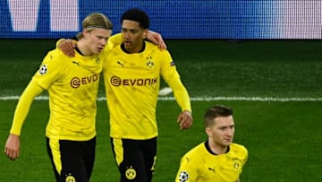 Dortmund's Norwegian forward Erling Braut Haaland (L) celebrates scoring the 2-0 goal with his teammates Dortmund's English midfielder Jude Bellingham (C) and Dortmund's German forward Marco Reus during the UEFA Champions League, Last-16 2nd-Leg football match BVB Borussia Dortmund v Sevilla FC at the Signal Iduna stadium in Dortmund, western Germany on March 9, 2021. (Photo by Ina Fassbender / various sources / AFP) (Photo by INA FASSBENDER/POOL/AFP via Getty Images)