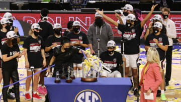 Mar 7, 2021; Greenville, SC, USA; South Carolina Gamecocks head coach Dawn Staley puts confetti on top of the SEC championship trophy after defeating the Georgia Lady Bulldogs in the SEC Conference Championship at Bon Secours Wellness Arena. Mandatory Credit: Dawson Powers-USA TODAY Sports