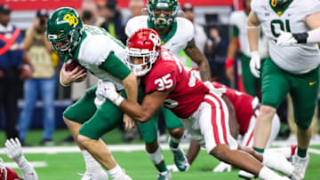 Dec 7, 2019; Arlington, TX, USA; Oklahoma Sooners linebacker Nik Bonitto (35) tackles Baylor Bears quarterback Charlie Brewer (12) during the first quarter in the 2019 Big 12 Championship Game at AT&T Stadium. Mandatory Credit: Kevin Jairaj-USA TODAY Sports