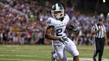 Sep 4, 2015; Kalamazoo, MI, USA; Michigan State Spartans running back Gerald Holmes (24) runs the ball against the Western Michigan Broncos during the 1st half of a game at Waldo Stadium. Mandatory Credit: Mike Carter-USA TODAY Sports