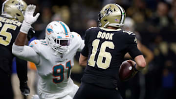 NEW ORLEANS, LOUISIANA - DECEMBER 27: Emmanuel Ogbah #91 of the Miami Dolphins sacks Ian Book #16 of the New Orleans Saints in the fourth quarter of the game at Caesars Superdome on December 27, 2021 in New Orleans, Louisiana. (Photo by Chris Graythen/Getty Images)