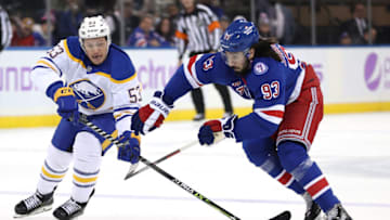 NEW YORK, NEW YORK - NOVEMBER 21: Jeff Skinner #53 of the Buffalo Sabres and Mika Zibanejad #93 of the New York Rangers go after the puck in the first period at Madison Square Garden on November 21, 2021 in New York City. (Photo by Elsa/Getty Images)