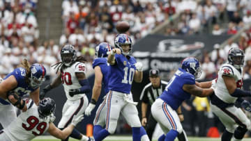 HOUSTON, TX - SEPTEMBER 23: Eli Manning #10 of the New York Giants throws a pass pressured by J.J. Watt #99, Jadeveon Clowney #90 and Christian Covington #95 of the Houston Texans in the second quarter at NRG Stadium on September 23, 2018 in Houston, Texas. (Photo by Tim Warner/Getty Images)