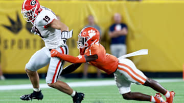 CHARLOTTE, NORTH CAROLINA - SEPTEMBER 04: Andrew Mukuba #1 of the Clemson Tigers tackles Brock Bowers #19 of the Georgia Bulldogs during the second half of the Duke's Mayo Classic at Bank of America Stadium on September 04, 2021 in Charlotte, North Carolina. (Photo by Grant Halverson/Getty Images)
