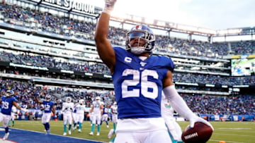 EAST RUTHERFORD, NEW JERSEY - DECEMBER 15: Saquon Barkley #26 of the New York Giants celebrates his touchdown in the fourth quarter against the Miami Dolphins at MetLife Stadium on December 15, 2019 in East Rutherford, New Jersey.The New York Giants defeated the Miami Dolphins 31-13. (Photo by Elsa/Getty Images)