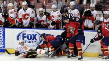 Nov 8, 2014; Sunrise, FL, USA; Calgary Flames left wing Jiri Hudler (24) collides with Florida Panthers center Vincent Trocheck (21) as right wing Jimmy Hayes (12) and right wing Scottie Upshall (19) look for the puck in the third period at BB&T Center. The Flames won 6-4. Mandatory Credit: Robert Mayer-USA TODAY Sports
