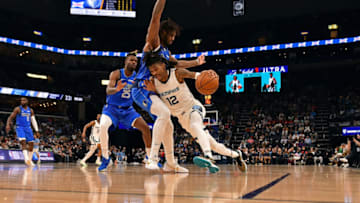 MEMPHIS, TENNESSEE - JANUARY 14: Ja Morant #12 of the Memphis Grizzlies handles the ball against Marquese Chriss #32 of the Dallas Mavericks during the second half at FedExForum on January 14, 2022 in Memphis, Tennessee. NOTE TO USER: User expressly acknowledges and agrees that, by downloading and or using this photograph, User is consenting to the terms and conditions of the Getty Images License Agreement. (Photo by Justin Ford/Getty Images)