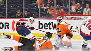 Sep 28, 2022; Philadelphia, Pennsylvania, USA; Washington Capitals center Dylan Strome (17) scores a goal against Philadelphia Flyers center Scott Laughton (21) and goaltender Samuel Ersson (33) during the third period at Wells Fargo Center. Mandatory Credit: Eric Hartline-USA TODAY Sports