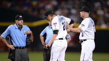 Jun 28, 2016; Phoenix, AZ, USA; Arizona Diamondbacks manager Chip Hale (3) takes starting pitcher Zack Greinke (21) out of the game after an injury during the third inning against the Philadelphia Phillies at Chase Field. Mandatory Credit: Joe Camporeale-USA TODAY Sports