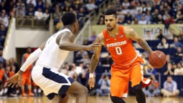 Dec 30, 2015; Pittsburgh, PA, USA; Syracuse Orange forward Michael Gbinije (0) dribbles the ball against Pittsburgh Panthers forward Jamel Artis (1) during the first half at the Petersen Events Center. Mandatory Credit: Charles LeClaire-USA TODAY Sports