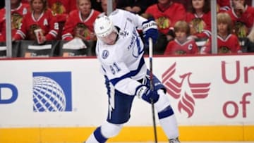 Oct 5, 2013; Chicago, IL, USA; Tampa Bay Lightning center Steven Stamkos (91) shoots the puck against the Chicago Blackhawks during the third period at the United Center. The Lightning beat the Blackhawks 3-2 in the shootout. Mandatory Credit: Rob Grabowski-USA TODAY Sports