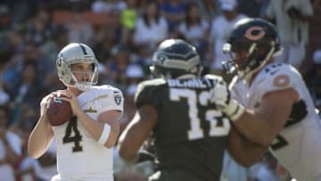 January 31, 2016; Honolulu, HI, USA; Team Rice quarterback Derek Carr of the Oakland Raiders (4) looks for a receiver against Team Irvin defensive end Michael Bennett of the Seattle Seahawks (72) during the second quarter of the 2016 Pro Bowl game at Aloha Stadium. Mandatory Credit: Kyle Terada-USA TODAY Sports