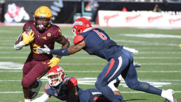 LAS VEGAS, NEVADA - DECEMBER 15: Running back Eno Benjamin #3 of the Arizona State Sun Devils runs for yardage against defensive backs Juju Hughes #23 and Anthoula Kelly #6 of the Fresno State Bulldogs during the Mitsubishi Motors Las Vegas Bowl at Sam Boyd Stadium on December 15, 2018 in Las Vegas, Nevada. (Photo by Ethan Miller/Getty Images)