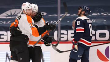 Feb 7, 2021; Washington, District of Columbia, USA; Philadelphia Flyers center Scott Laughton (21) celebrates with Flyers left wing Michael Raffl (12) after scoring a goal as Washington Capitals left wing Alex Ovechkin (8) skates away in the third period at Capital One Arena. Mandatory Credit: Geoff Burke-USA TODAY Sports