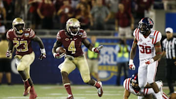 Sep 5, 2016; Orlando, FL, USA; Florida State Seminoles running back Dalvin Cook (4) runs in the fourth quarter as Mississippi Rebels defensive back Zedrick Woods (36) defends at Camping World Stadium. Florida State Seminoles won 45-34. Mandatory Credit: Logan Bowles-USA TODAY Sports
