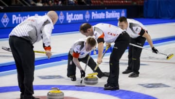 (From L) World Champion Canada's team: skip Kevin Koe, third Marc Kennedy, second Brent Laing and lead Ben Hebert competes during the gold medal game against Denmark at the World Men's Curling Championships on April 10, 2016 in Basel. / AFP / FABRICE COFFRINI (Photo credit should read FABRICE COFFRINI/AFP/Getty Images)