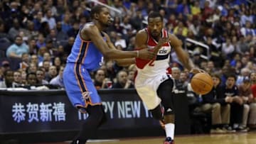 Feb 1, 2014; Washington, DC, USA; Washington Wizards point guard John Wall (2) dribbles the ball as Oklahoma City Thunder small forward Kevin Durant (35) defends in the first quarter at Verizon Center. Mandatory Credit: Geoff Burke-USA TODAY Sports