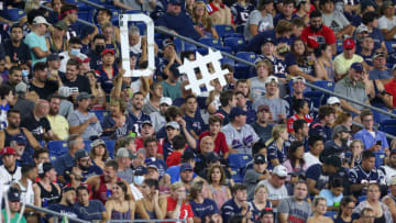 Aug 12, 2021; Foxborough, Massachusetts, USA; New England Patriots fans hold up a defense sign during the second half against the Washington Football Team at Gillette Stadium. Mandatory Credit: Paul Rutherford-USA TODAY Sports