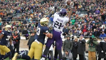 Nov 15, 2014; South Bend, IN, USA; Northwestern Wildcats wide receiver Kyle Prater (21) catches a pass in the end zone for a touchdown against Notre Dame Fighting Irish safety Drue Tranquill (23) at Notre Dame Stadium. Mandatory Credit: Brian Spurlock-USA TODAY Sports
