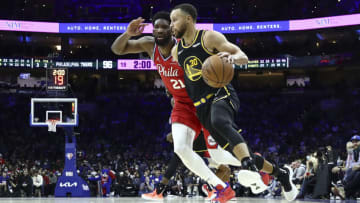 PHILADELPHIA, PENNSYLVANIA - DECEMBER 11: Stephen Curry #30 of the Golden State Warriors drives past Joel Embiid #21 of the Philadelphia 76ers during the fourth quarter at Wells Fargo Center on December 11, 2021 in Philadelphia, Pennsylvania. NOTE TO USER: User expressly acknowledges and agrees that, by downloading and or using this photograph, User is consenting to the terms and conditions of the Getty Images License Agreement. (Photo by Tim Nwachukwu/Getty Images)