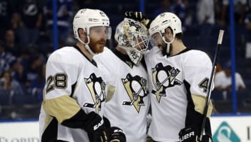 May 24, 2016; Tampa, FL, USA; Pittsburgh Penguins goalie Matt Murray (30), defenseman Justin Schultz (4), defenseman Ian Cole (28) congratulate each other after they beat the Tampa Bay Lightning of game six of the Eastern Conference Final of the 2016 Stanley Cup Playoffs at Amalie Arena. Tampa Bay Lightning defeated the Pittsburgh Penguins 5-2. Mandatory Credit: Kim Klement-USA TODAY Sports