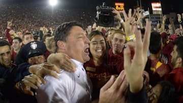 Nov 16, 2013; Los Angeles, CA, USA; Southern California Trojans coach Ed Orgeron celebrates with fans at the end of the game against the Stanford Cardinal at Los Angeles Memorial Coliseum. USC defeated Stanford 20-17. Mandatory Credit: Kirby Lee-USA TODAY Sports
