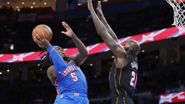 Oklahoma City Thunder forward Luguentz Dort (5) goes up for a basket as Miami Heat center Dewayne Dedmon (21) defends (Alonzo Adams-USA TODAY Sports)
