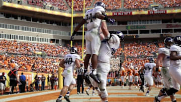 Jan 1, 2016; Tampa, FL, USA; Northwestern Wildcats running back Justin Jackson (21) is congratulated as he scores a touchdown against the Tennessee Volunteers during the first half in the 2016 Outback Bowl at Raymond James Stadium. Mandatory Credit: Kim Klement-USA TODAY Sports