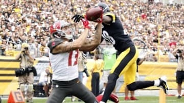 Sep 28, 2014; Pittsburgh, PA, USA; Tampa Bay Buccaneers wide receiver Mike Evans (13) catches a seven yard touchdown pass against Pittsburgh Steelers cornerback Cortez Allen (28) during the first quarter at Heinz Field. Mandatory Credit: Charles LeClaire-USA TODAY Sports