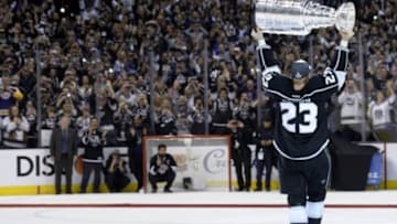 Jun 13, 2014; Los Angeles, CA, USA; Los Angeles Kings right wing Dustin Brown (23) hoists the Stanley Cup after defeating the New York Rangers game five of the 2014 Stanley Cup Final at Staples Center. Mandatory Credit: Gary A. Vasquez-USA TODAY Sports