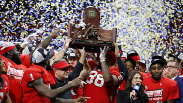 Head coach Kirby Smart and the Georgia Bulldogs celebrate with the trophy after defeating the LSU Tigers in the SEC Championship Game. (Photo by Todd Kirkland/Getty Images)